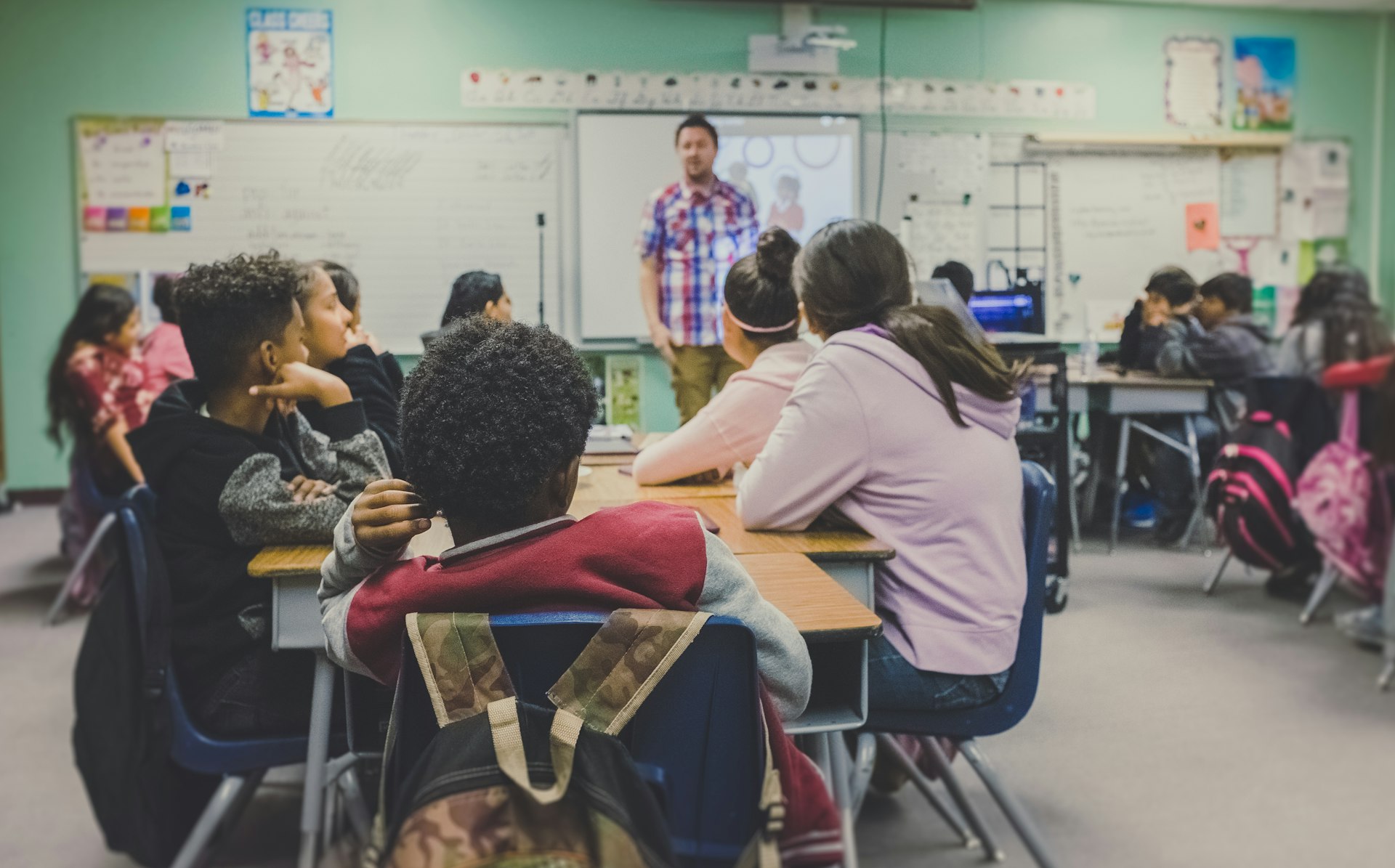 A teacher with students in an international classroom